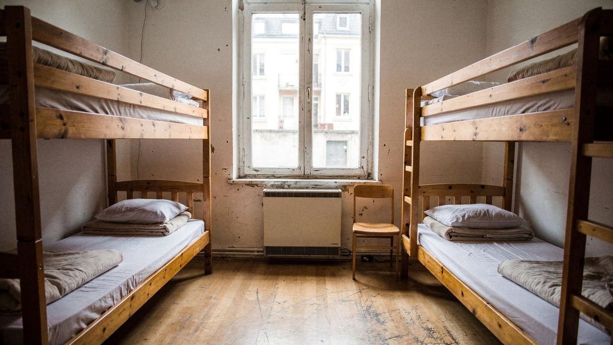 Shared hostel dormitory with bunk beds used on a student coach tour in Europe